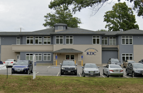 Building with multiple cars parked in front of it