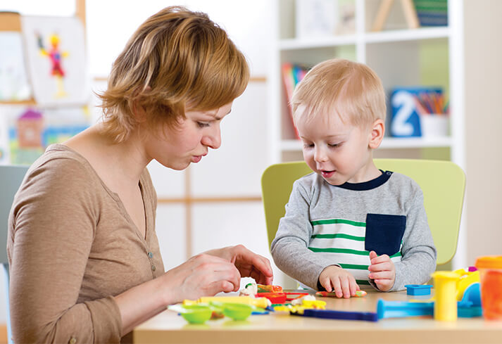 Adult woman playing with a child in a school setting